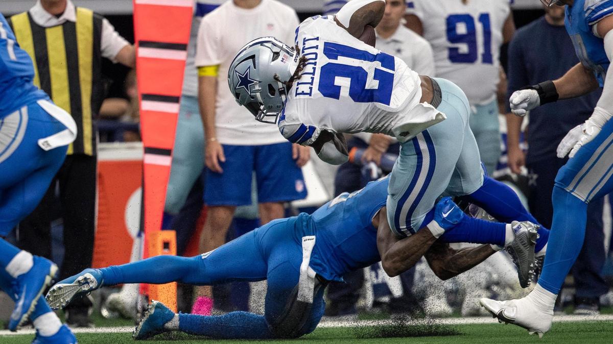 Dallas Cowboys running back Ezekiel Elliott completes a pass before being tackled during their game against the Detroit Lions at the AT&T Stadium in Arlington on Sunday, Oct. 23, 2022.