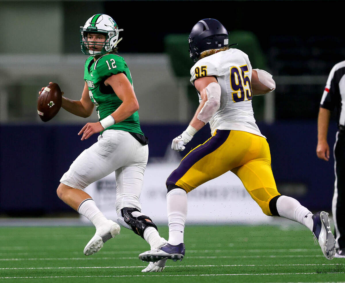 Southlake Carroll quarterback Kaden Anderson (12) tries to elude Highland Park defensive lineman Jack Curtis (95) during the second quarter, Thursday night, August 26, 2021 played at AT&T Stadium in Arlington, TX. (Steve Nurenberg Special to the Star-Telegram)