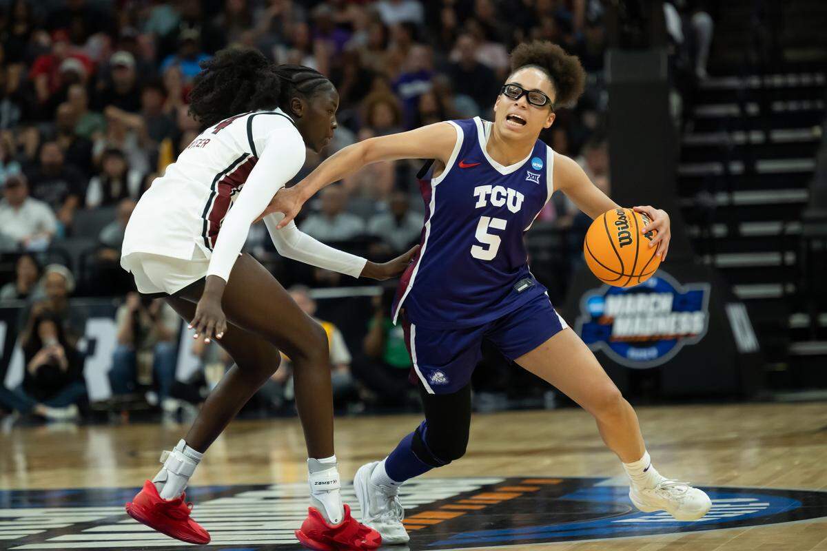 TCU guard Olivia Miles (5) drives around South Carolina guard Agot Makeer in the Elite Eight of the NCAA Tournament on Monday at Golden 1 Center in Sacramento, Calif.
