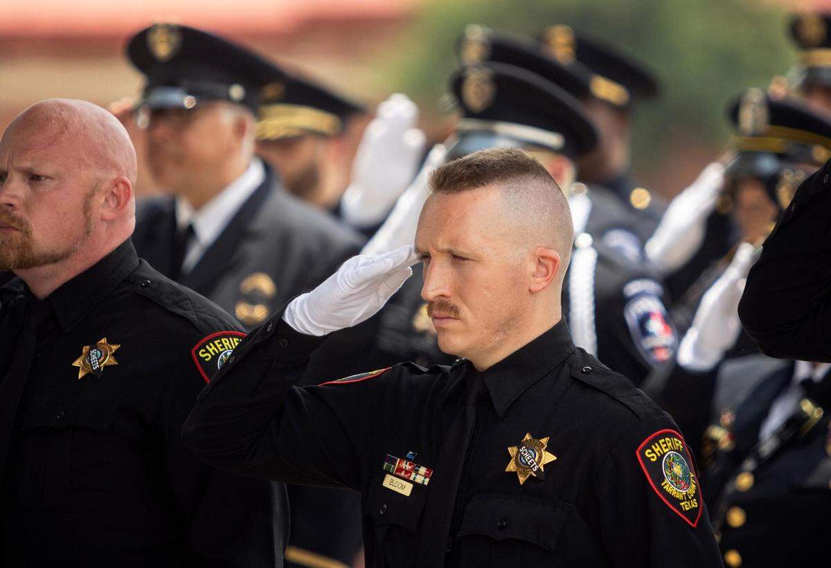 Tarrant County sheriff’s deputies salute during the funeral of fellow Tarrant County Sheriff’s Deputy Billy W. Scheets on Thursday in Fort Worth. Scheets had served with the Tarrant County Sheriff’s Office since 2003