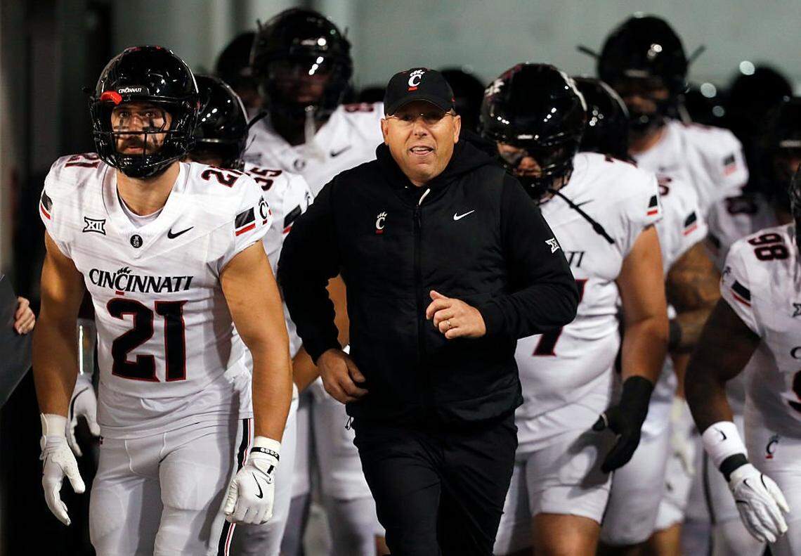 SALT LAKE CITY, UT - NOVEMBER 1: Head coach Scott Satterfield of the Cincinnati Bearcats brings his team onto the field to start their game against the Utah Utes at Rice-Eccles Stadium on November 1, 2025 in Salt Lake City, Utah. (Photo by Chris Gardner/Getty Images)