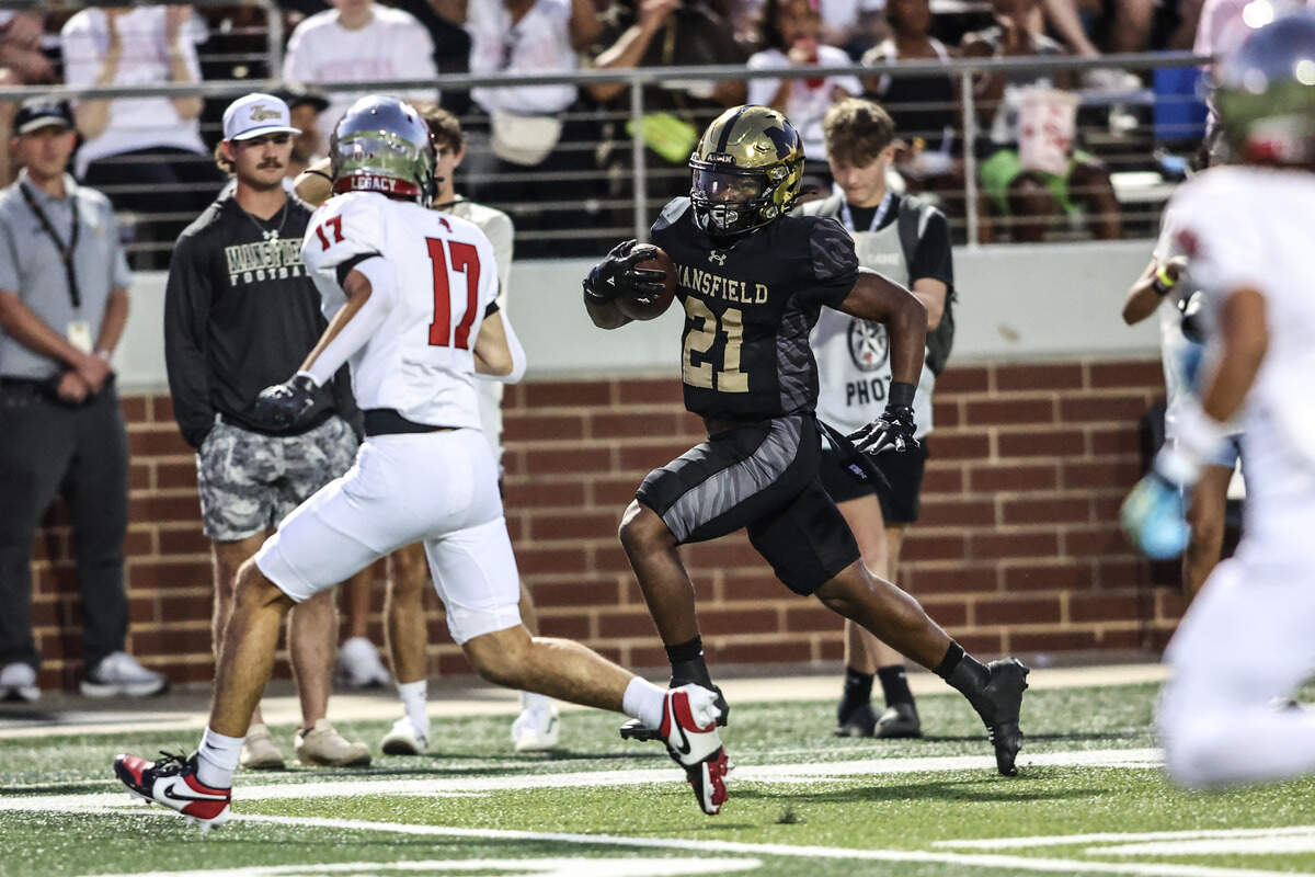 Mansfield running back Raymond Weaver carries the ball against Mansfield Legacy In Friday’s game at Vernon Newsom Stadium. Special to the Star-Telegram / Tom Marvin