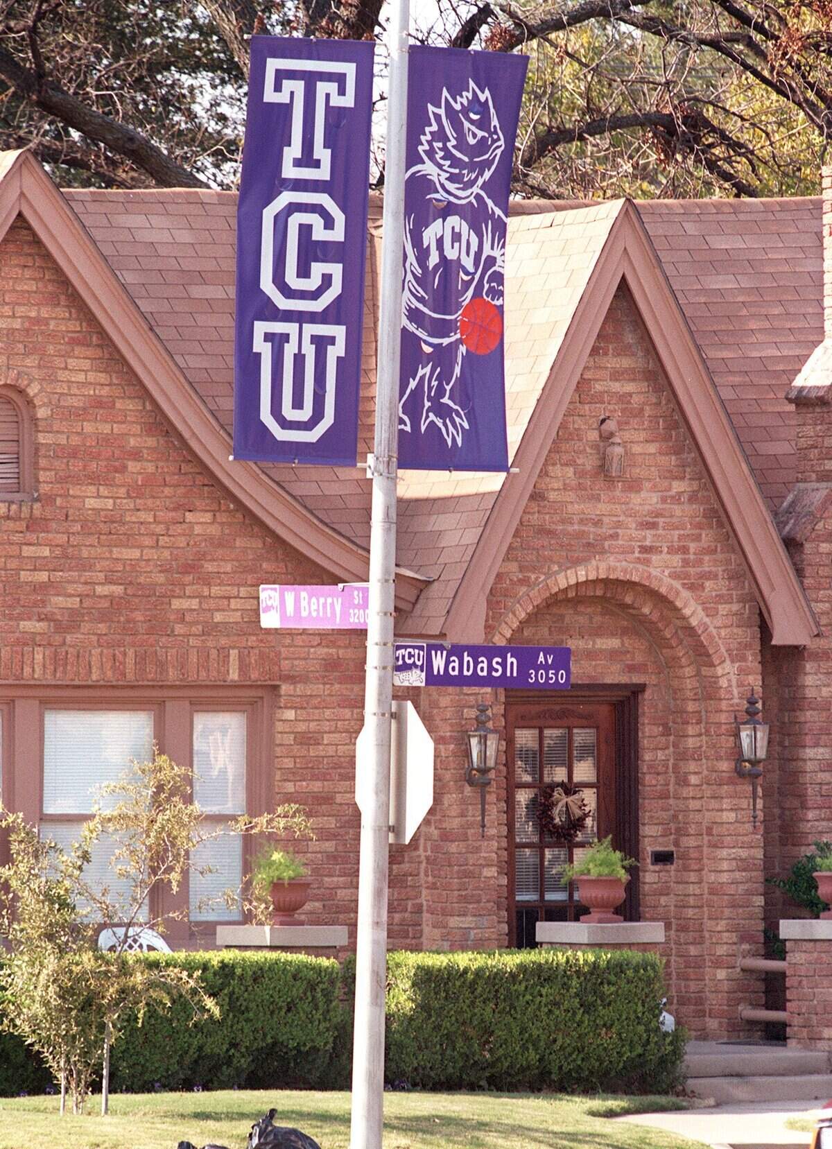 Texas Christian University is trying to improve it's relationship with the neighborhood which it is surrounded by. The TCU banners line Berry St. in front of a home on the corner of Wabash Ave., one block from the edge of campus. Nov 30, 1999 Fort Worth Star-Telegram photo by Ron T. Ennis
