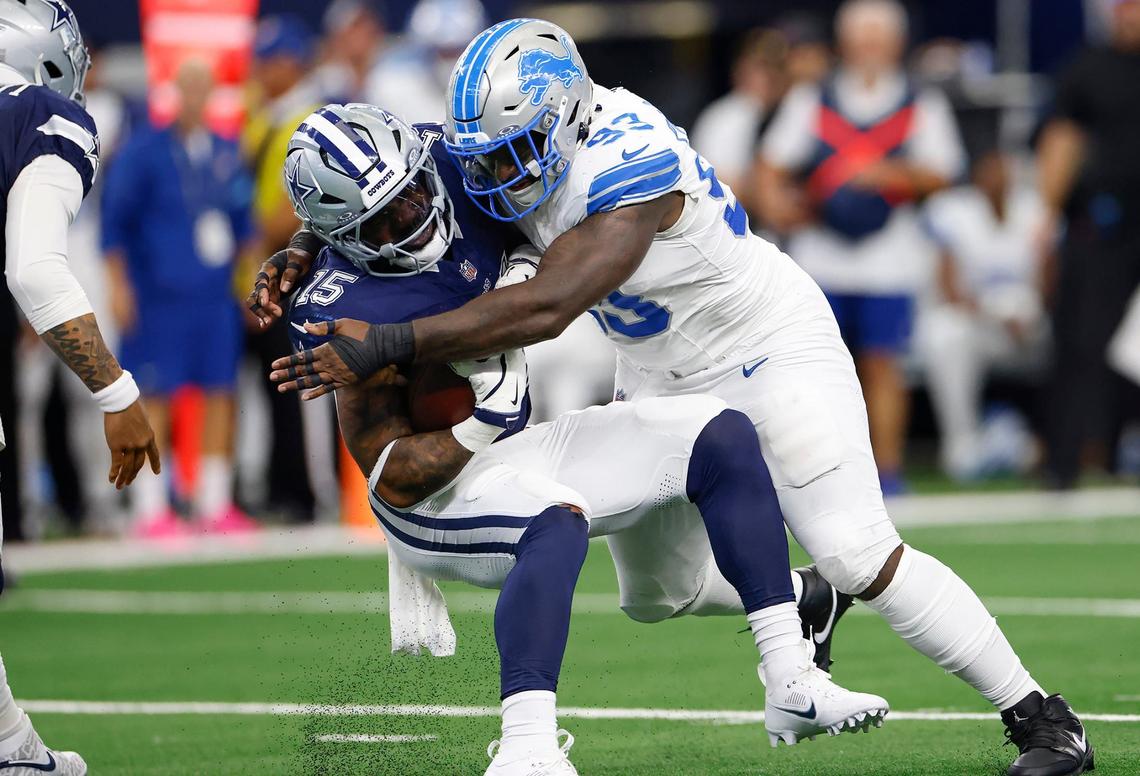 Dallas Cowboys running back Ezekiel Elliott is tackled by Detroit Lions defensive lineman Josh Paschal on Sunday, Oct. 13, 2024, at AT&T Stadium in Arlington.