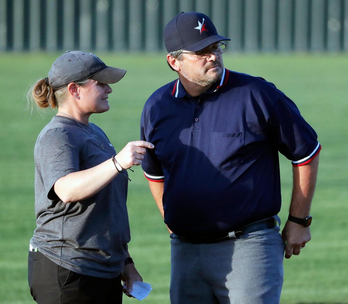 Lake Ridge head coach Bobbi Cruff talks over a call with the third base umpire during a UIL 6A Region 2 area round softball name at Lake Ridge High School in Mansfield, Texas, Friday, May 06, 2022. Lake Ridge defeated Tyler Legacy 6-3 on 16 hits and no errors to move on to the next round. (Special to the Star-Telegram Bob Booth)