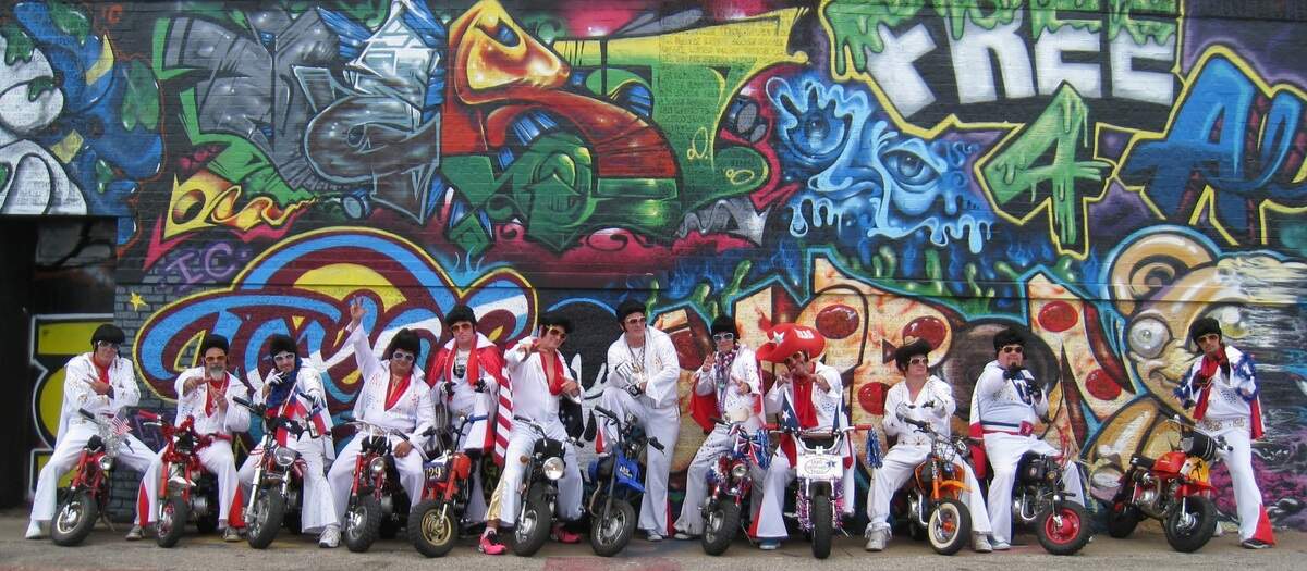 The motley crew of “The World Famous Wheelie-ing Elvi” pose for a photo.