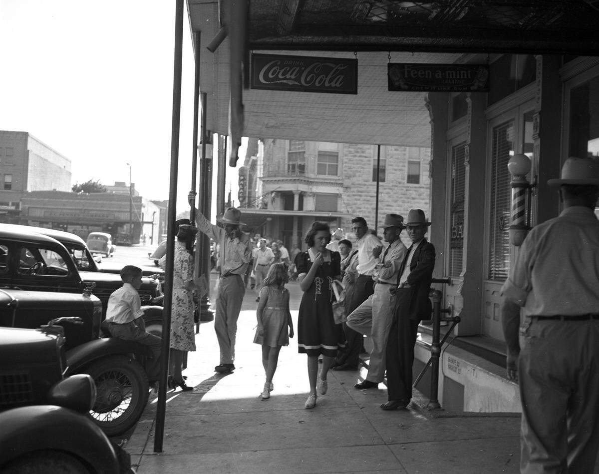 July 8, 1939: At Trading Day in Weatherford, a typical sidewalk scene in the business section of Weatherford includes shoppers and farmers.