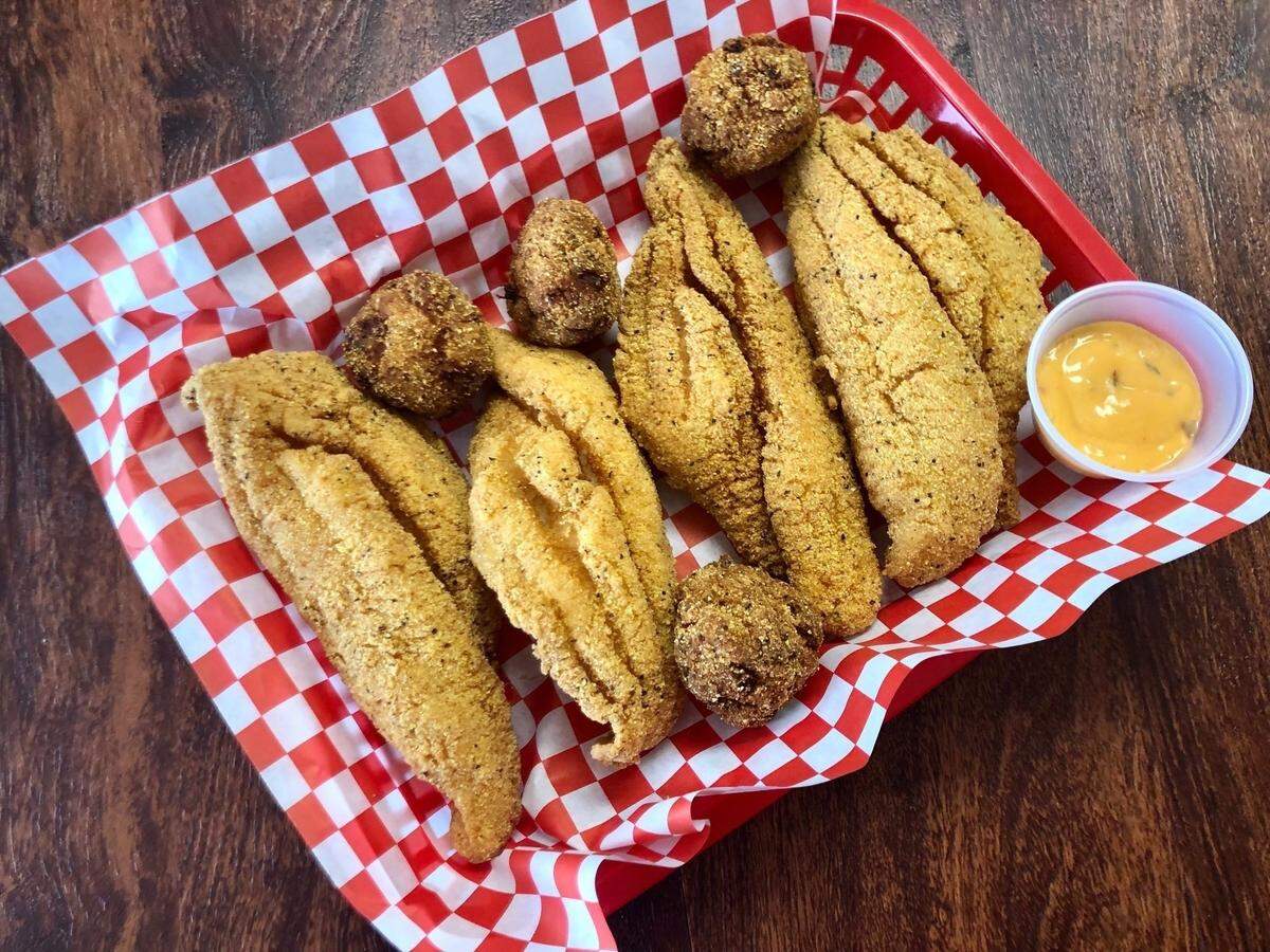 Belzoni’s Catfish is crispy enough to pick up and eat as finger food. (Shown with sriracha tartar sauce.)