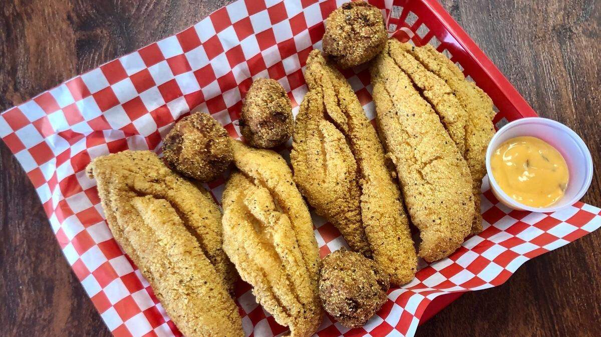 Belzoni’s Catfish is crispy enough to pick up and eat as finger food. (Shown with sriracha tartar sauce.)