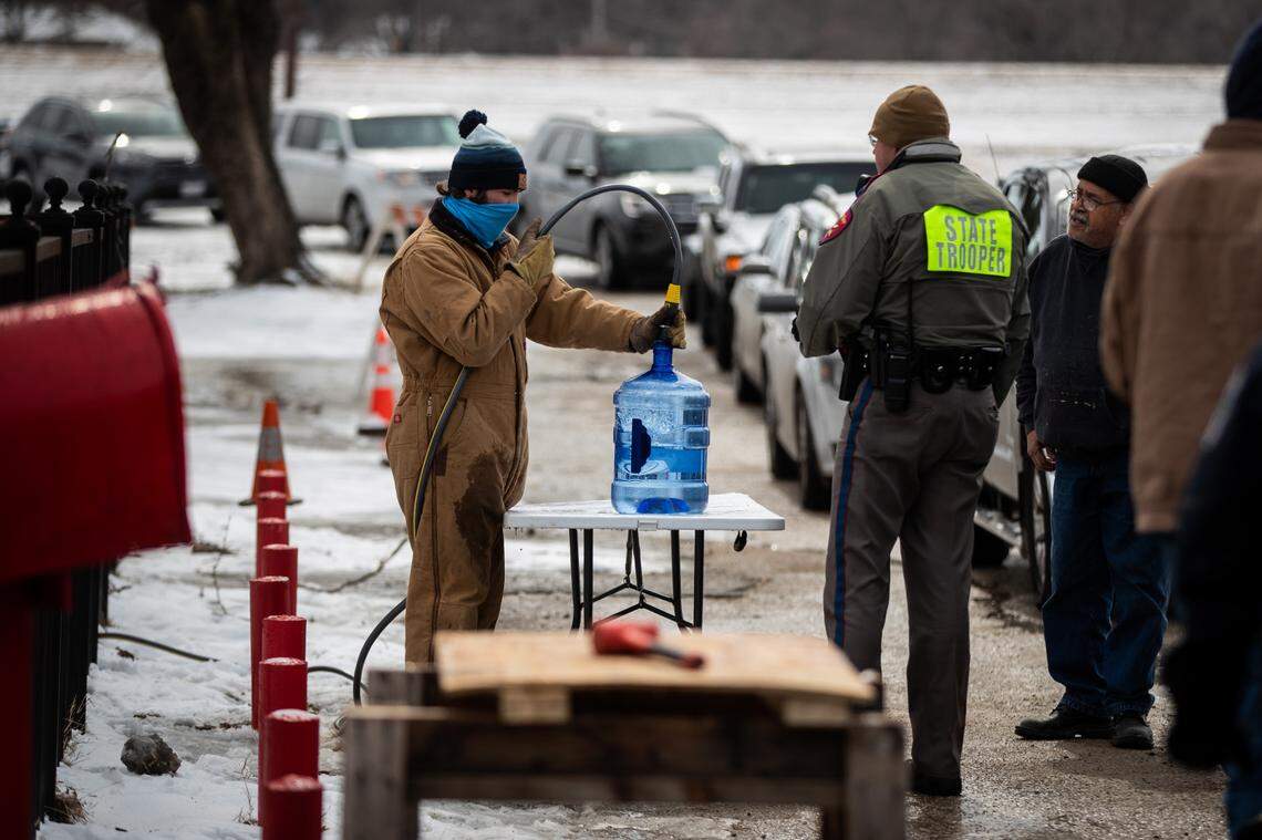 Burger’s Lake put a hose on their natural spring and are suppling people with clean water on Feb. 18, 2021, in Fort Worth. The spring flows to the Trinity River in the winter and it was diverted to help people during the storm.