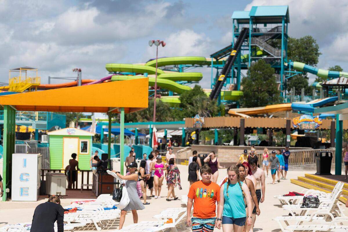 People make their way around to rides Wednesday, June 1, 2022, at Hurricane Harbor in Arlington.