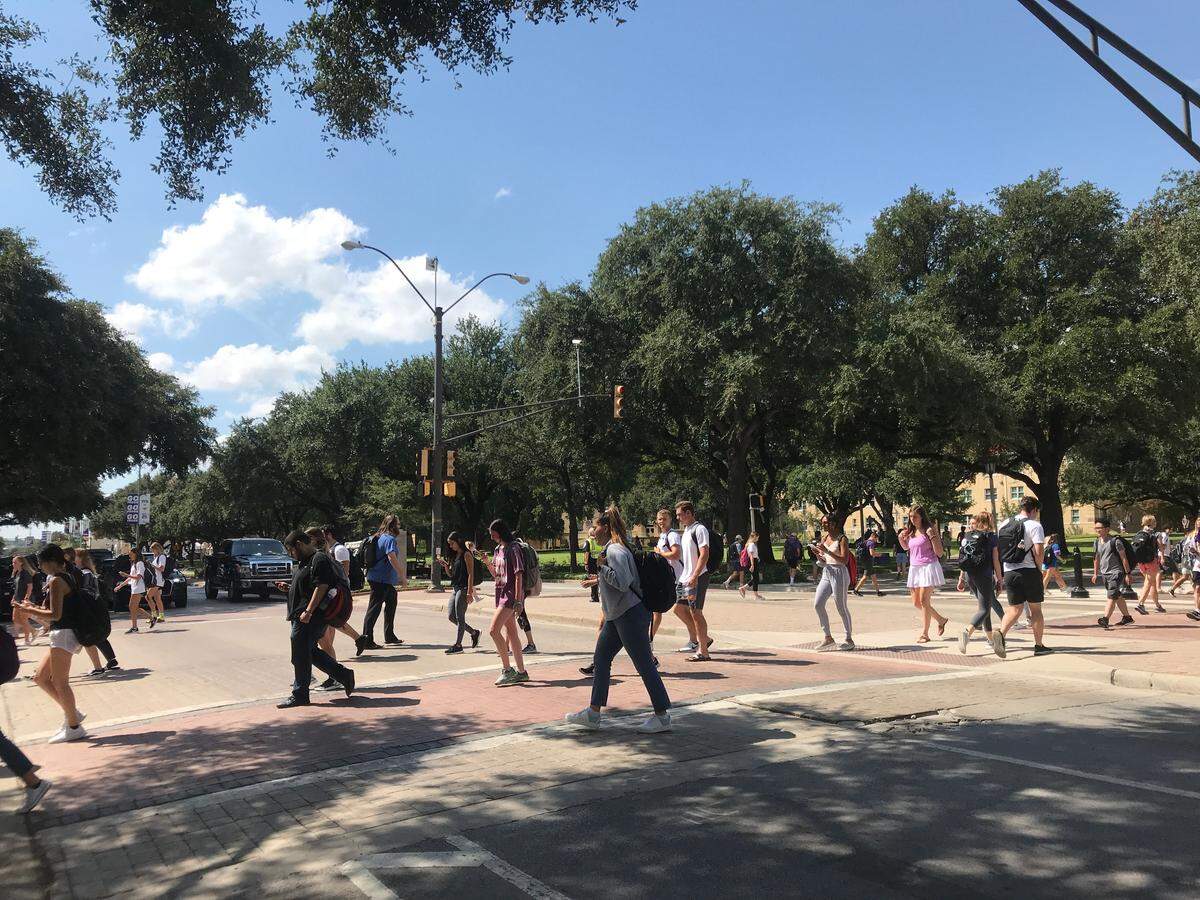 Texas Christian University students walk across University Drive at the main crosswalk with a traffic light on Sept. 13. Excessive pedestrian foot traffic has been an issue on the TCU campus for years, but the college is this year weighing options to combat the problem.