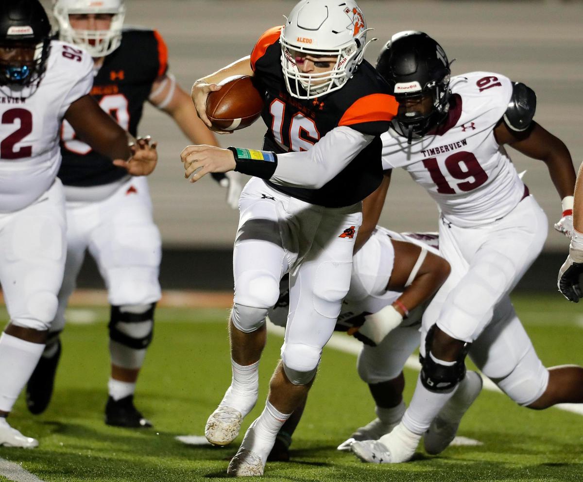 Aledo quarterback Brayden Fowler-Nicolosi (16) scrambles in the backfield and completed a short pass in a high school district 5-5A division 2 football game at Bearcat Stadium in Aledo, Texas, Friday Oct. 15, 2021. After a late second quarter Timberview touchdown the score was knotted at 14 at the half. (Special to the Star-Telegram Bob Booth)