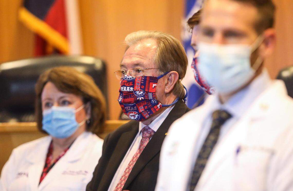 Judge Glen Whitley, center, and American Medical Association President Susan Bailey, left, attend a June 25 press conference where Whitley announced that patrons at all Tarrant County businesses and outdoor gatherings were required to wear masks..