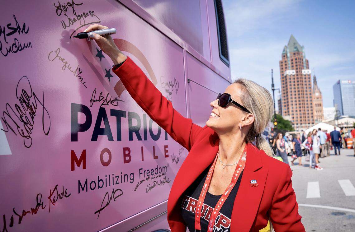 Leigh Wambsganss of Patriot Mobile signed a Concerned Women for America campaign bus July 16, 2024, at the Republican National Convention in Milwaukee, Wisconsin.