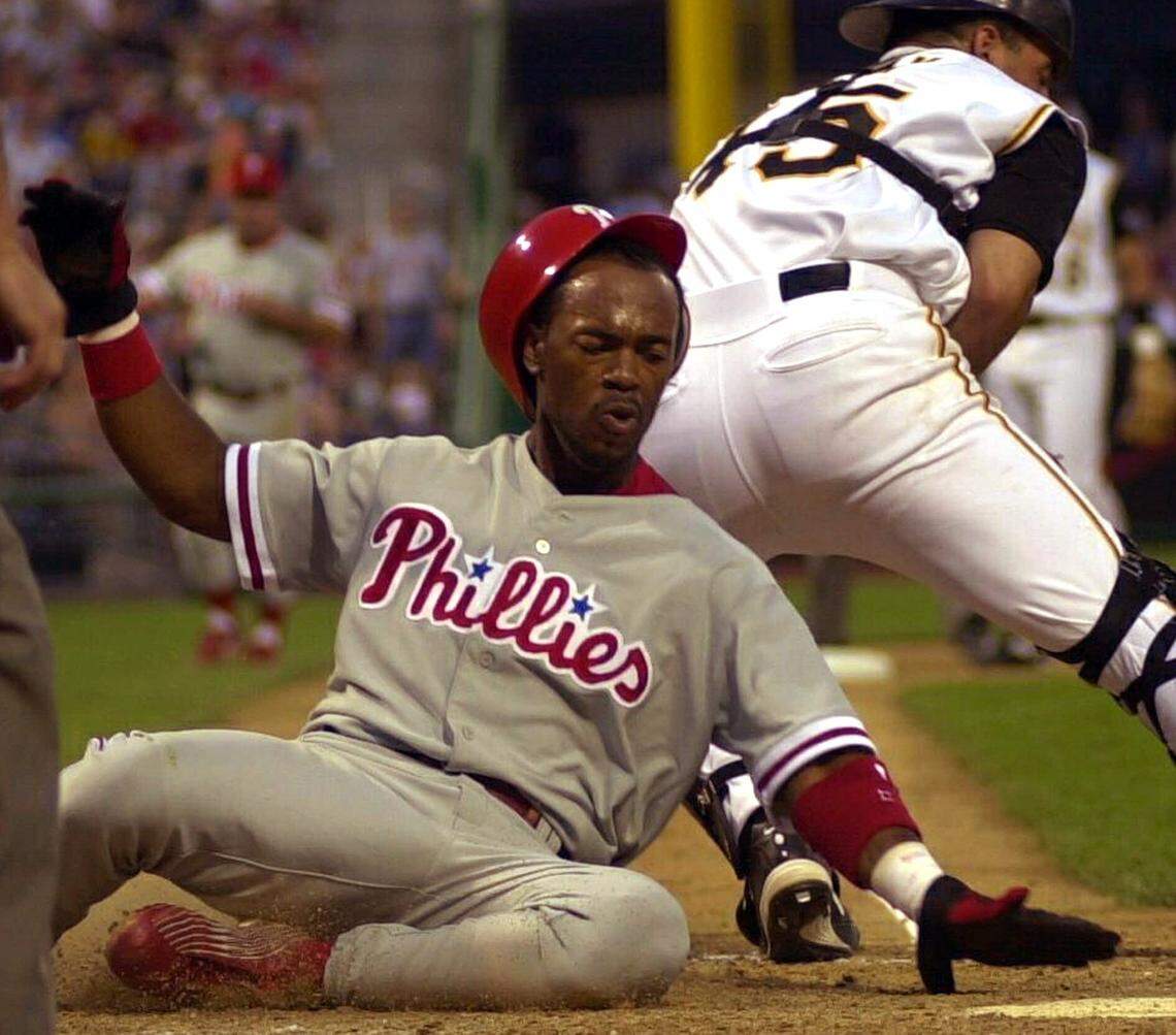 Philadelphia Phillies’ Jimmy Rollins scores past Pittsburgh Pirates catcher Keith Osik on June 19, 2001, in Pittsburgh. (AP Photo/Gene J. Puskar)