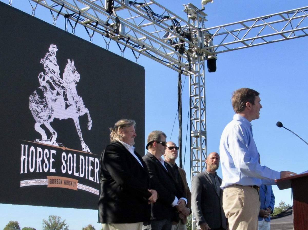 Kentucky Gov. Andy Beshear prepared to present Kentucky Colonel certificates to officials with Horse Soldier Farms on Oct. 19, 2021, when plans were announced for an Urban Stillhouse restaurant, bourbon distillery and other attractions in Somerset, Kentucky.