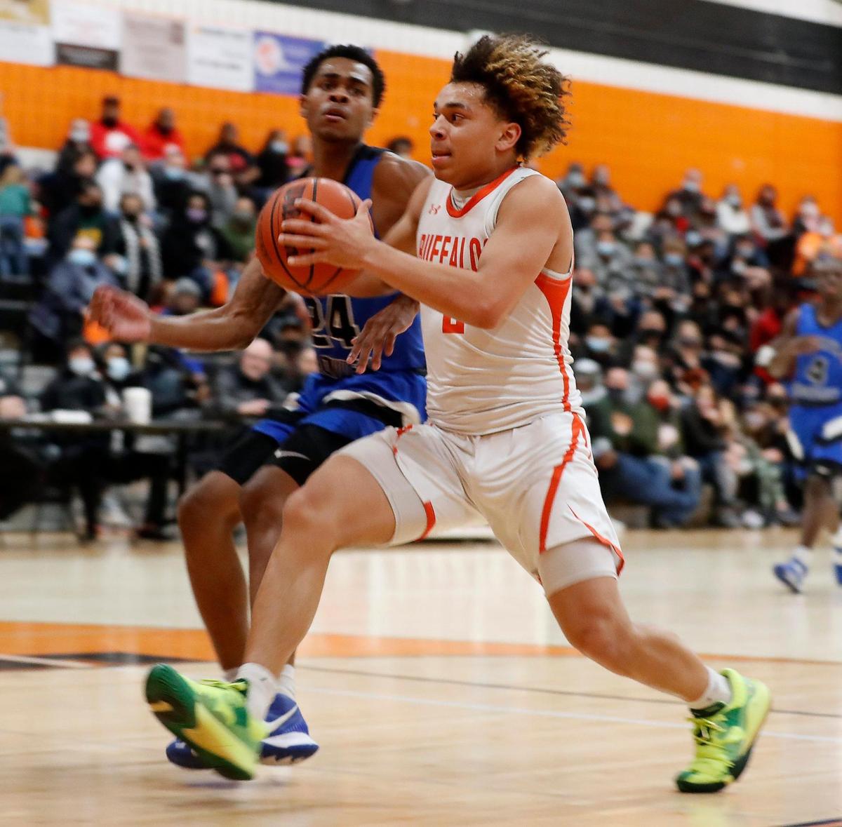 Haltom guard Kyron Powell (2) puts in a shot defended by North Crowley wing Trey Davis (24) during a District 3-6A Bi-district basketball game at Haltom High School in Haltom City, Texas, Friday, Feb. 12, 2021. North Crowley defeated Haltom 55-45. (Special to the Star-Telegram Bob Booth)