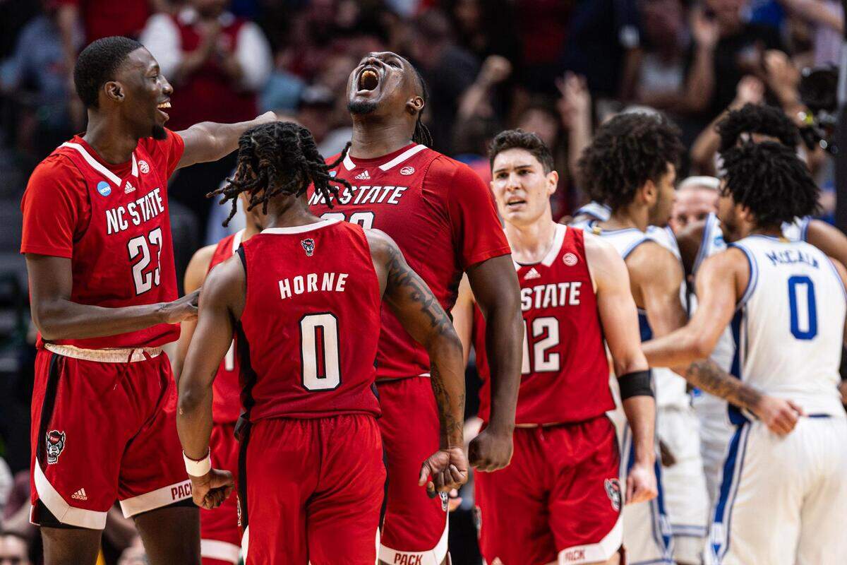 NC State forward DJ Burns Jr. (30) celebrates with his teammates after making a shot while getting fouled late in the second half of the Elite 8 South Regional Championship game of NCAA Division I Mens Basketball Tournament at American Airlines Center in Dallas on Sunday, March 31, 2024. NC State defeated Duke 76-64.