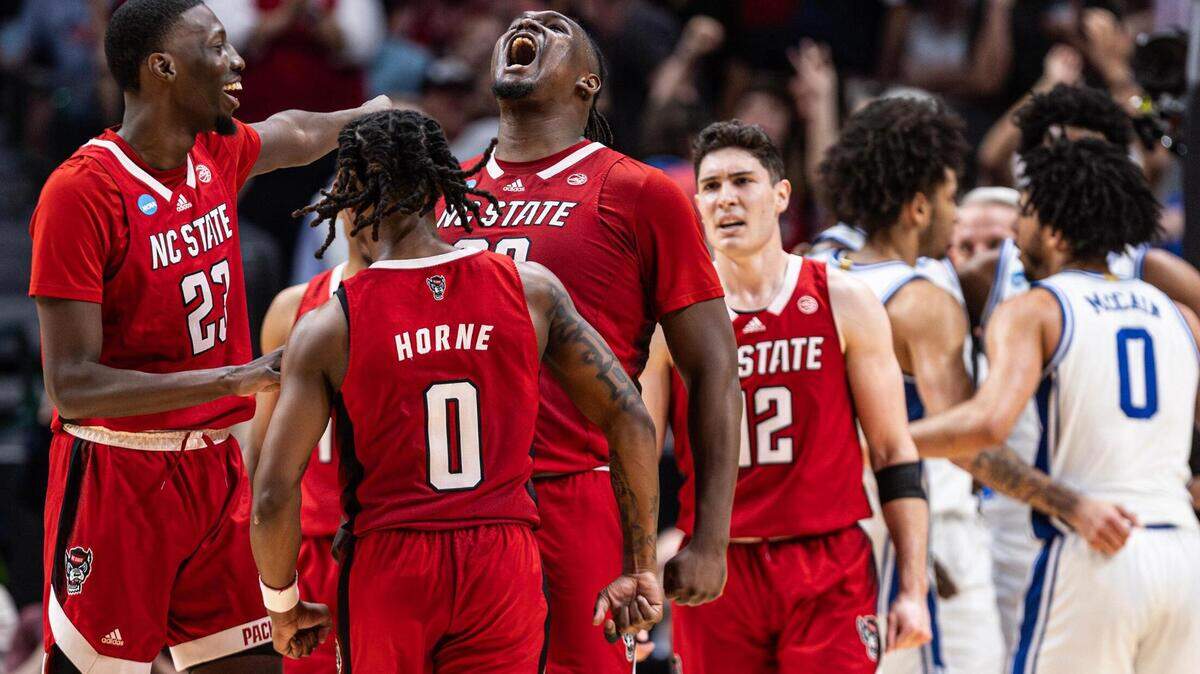NC State forward DJ Burns Jr. (30) celebrates with his teammates after making a shot while getting fouled late in the second half of the Elite 8 South Regional Championship game of NCAA Division I Mens Basketball Tournament at American Airlines Center in Dallas on Sunday, March 31, 2024. NC State defeated Duke 76-64.