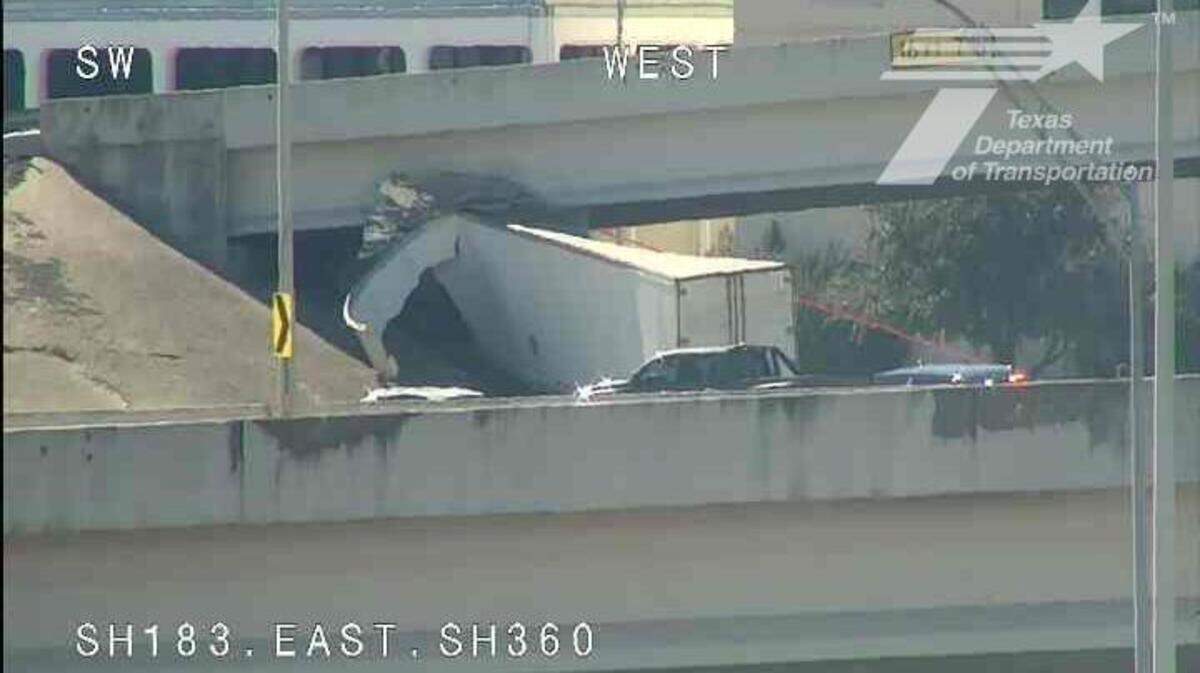 Two people were injured after an 18-wheeler crashed and became stuck under a bridge near the intersection of State Highway 183 and State Highway 360 on Monday afternoon, Feb. 24.