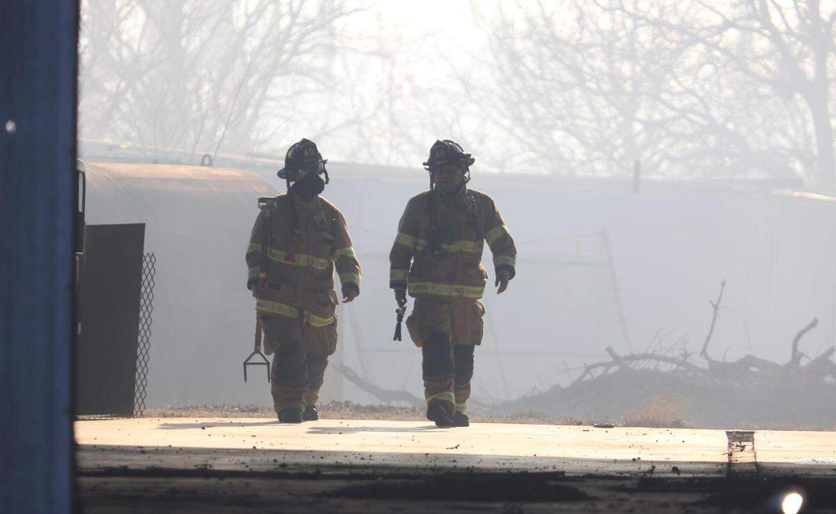 Firefighters work to contain a grass fire in Kennedale on Tuesday, February 15, 2022. Everman Fire Department Chief Landon Whatley said the fire burned between 75 to 100 acres and damaged one structure.