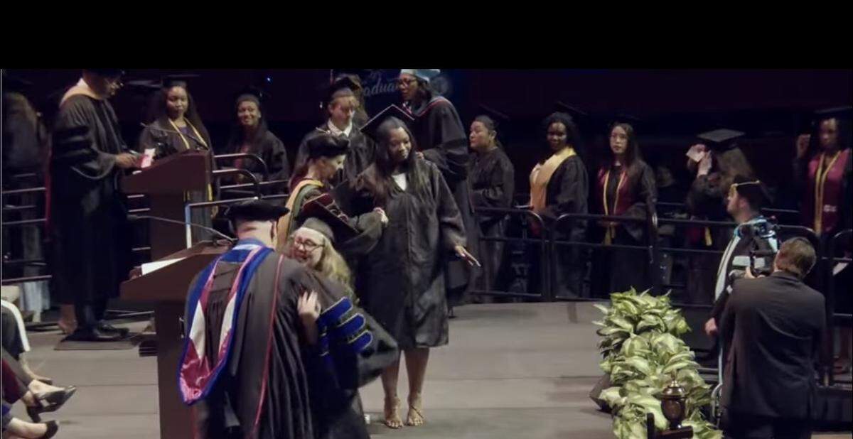 TCC graduate Mackenzie Sutton celebrates with her adoptive father, TCC professor David Sutton, at TCC’s graduation ceremony in Fort Worth on May 15, 2026.