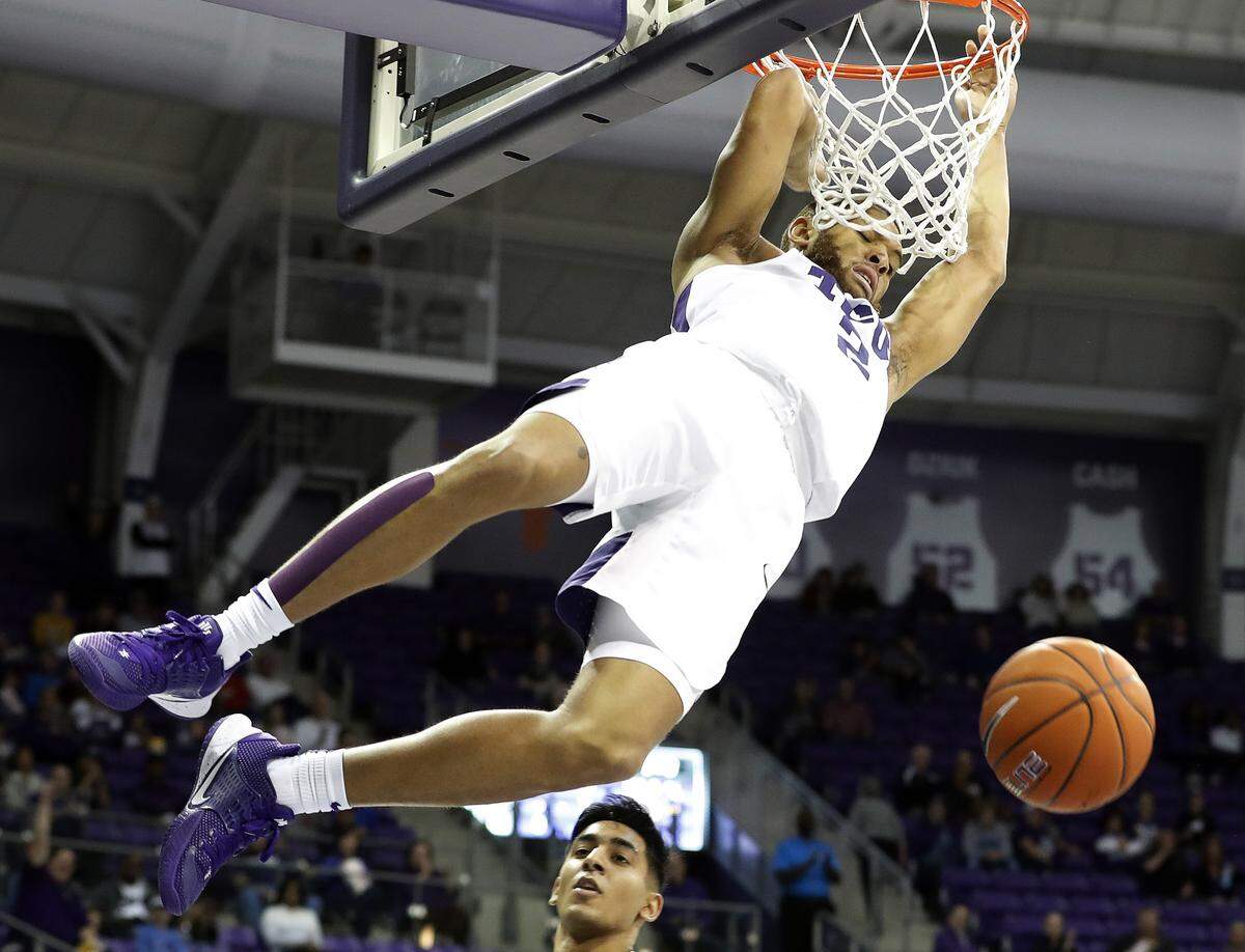 TCU guard Edric Dennis (2) hangs on the rim after scoring two in the first half of an NCAA basketball game at Schollmaier Arena in Fort Worth, Texas, Saturday, Dec. 14, 2019.