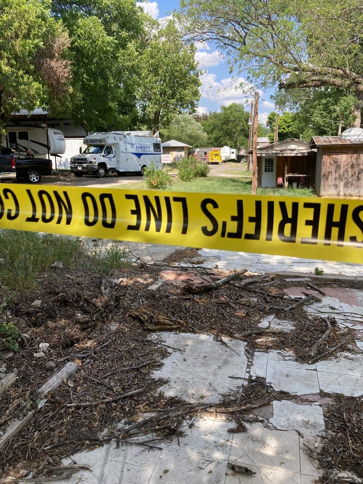 Crime scene tape blocks off an area in a Tarrant County mobile home park where a standoff occurred in which authorities said a man shot at law enforcement and set fire to his home with incendiary devices on June 23, 2022.