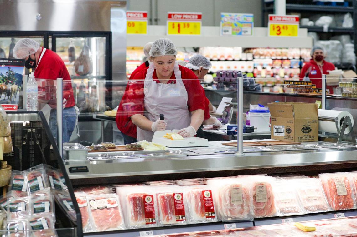 An H-E-B worker slices cheese for charcuterie boards offered at its newest location in Frisco, Texas, on Sept. 20.
