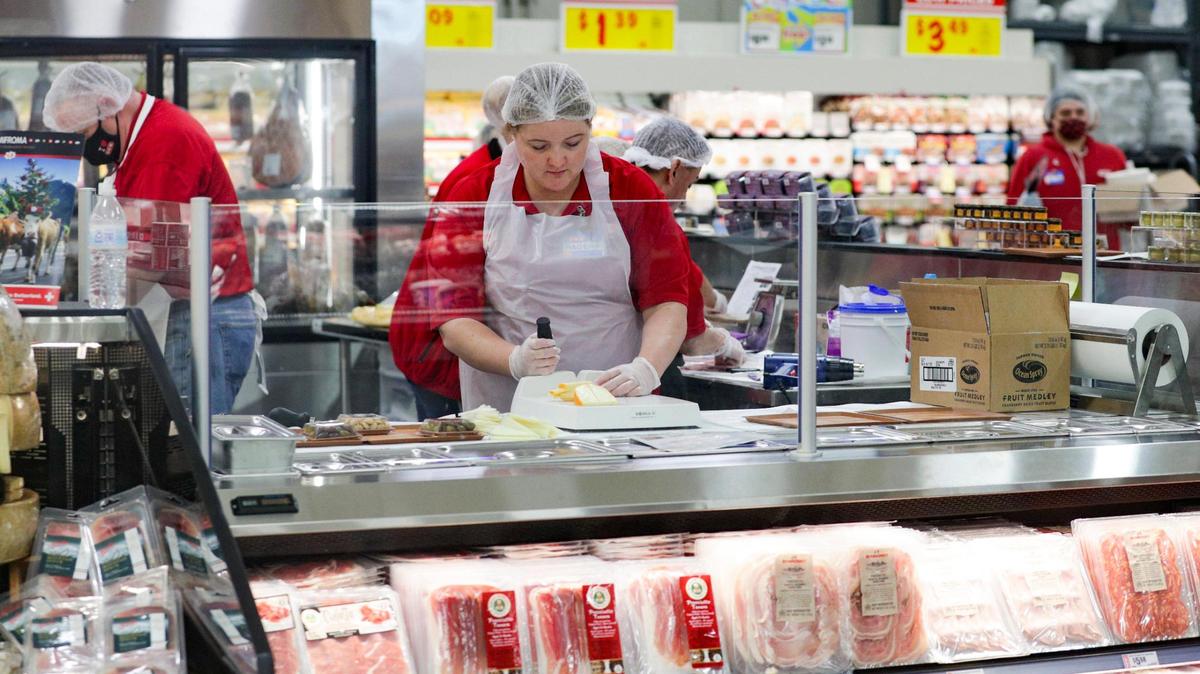 An H-E-B slices cheese for charcuterie boards offered at their newest location in Frisco, Texas, on Tuesday, Sept. 20, 2022. H-E-B stores currently under construction in Plano, McKinney and Allen will employ 750 people each.