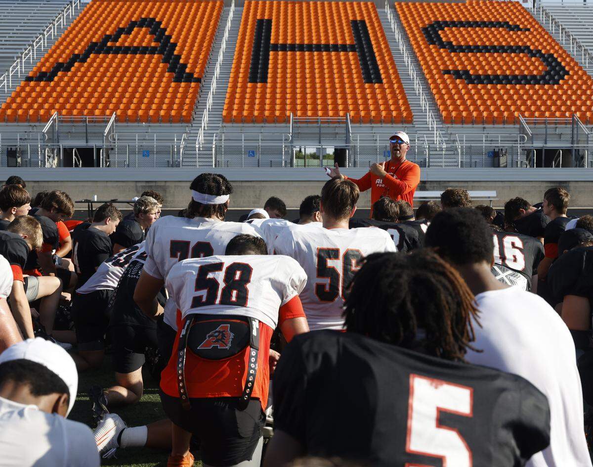 Head coach Robby Jones talks to the team after Aledo High School's morning practice at Tim Buchanan Stadium in Aledo, Texas, Monday August, 18, 2025.