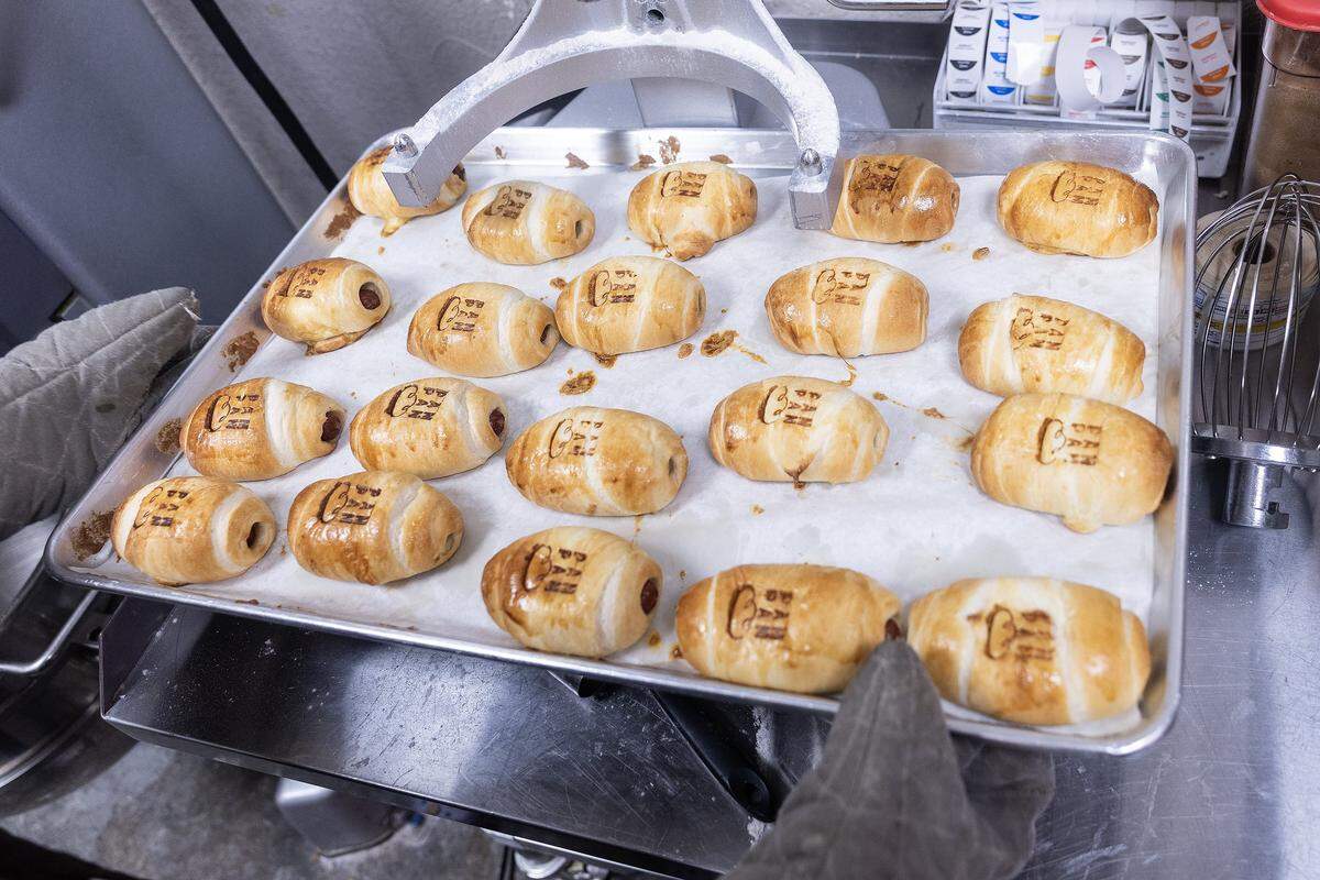 Beef sausage kolaches are branded with the Pan Pan logo before being served to customers.