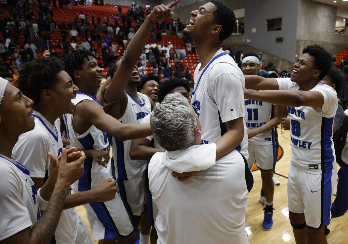 Teammates lift North Crowley guard Tyler Hastings after he made the game-winning 3-pointer against Duncanville in a Class 6A Division I state semifinal Tuesday at Wilkerson-Greines Activity Center in Fort Worth.