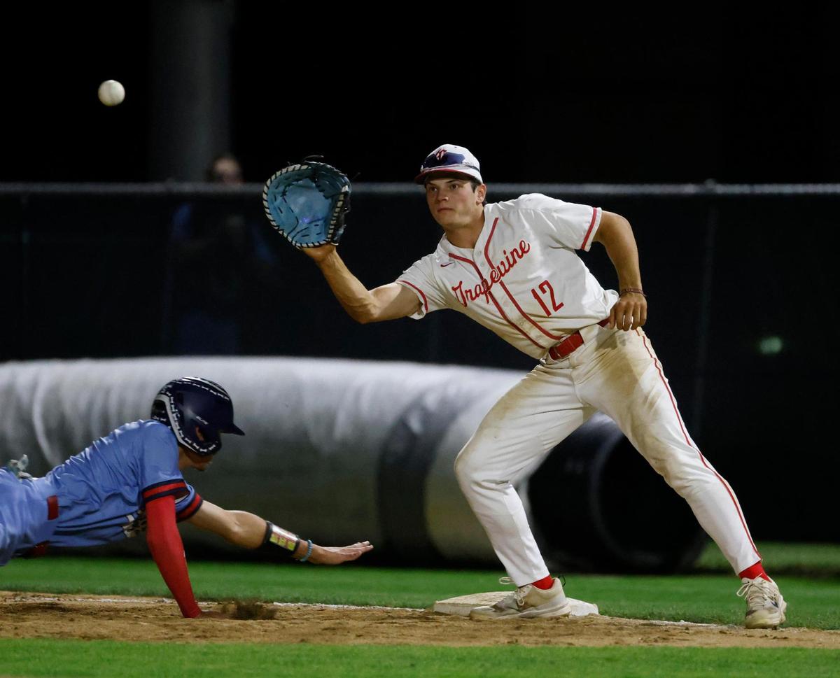 Richland designated hitter Aiden Majerus (8) gets back to first safely as Grapevine first baseman Jarett Boswell (12) awaits the ball during a UIL baseball game at Grapevine Mustang Field in Grapevine, Texas, Thursday, Apr. 17, 2025.