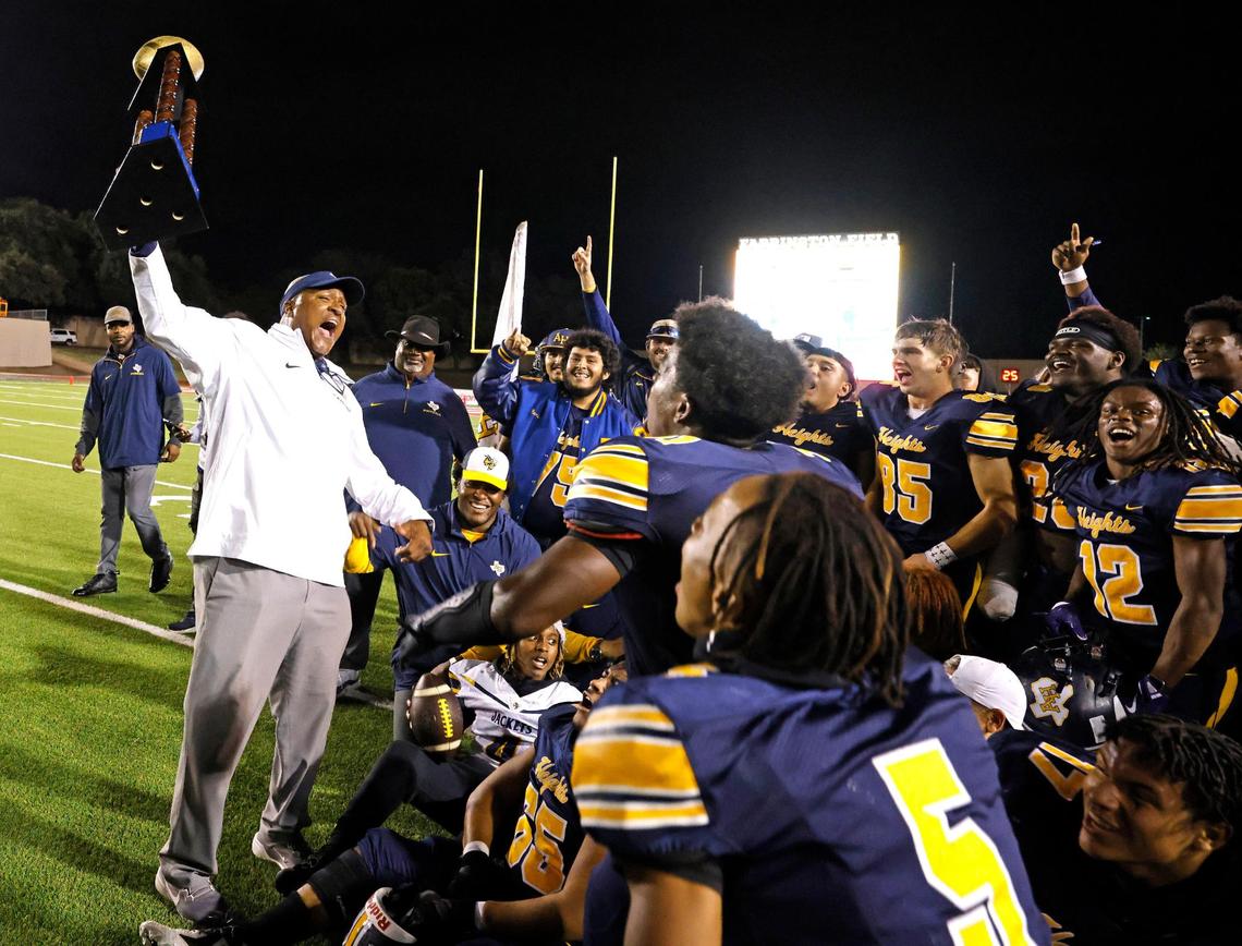 Arlington Heights head coach Curtis James celebrates winning the Battle of the Bonfire with his team after a UIL District 4-5A D1 football game at Farrington Field in Fort Worth, Texas, Friday, Nov. 08, 2024.