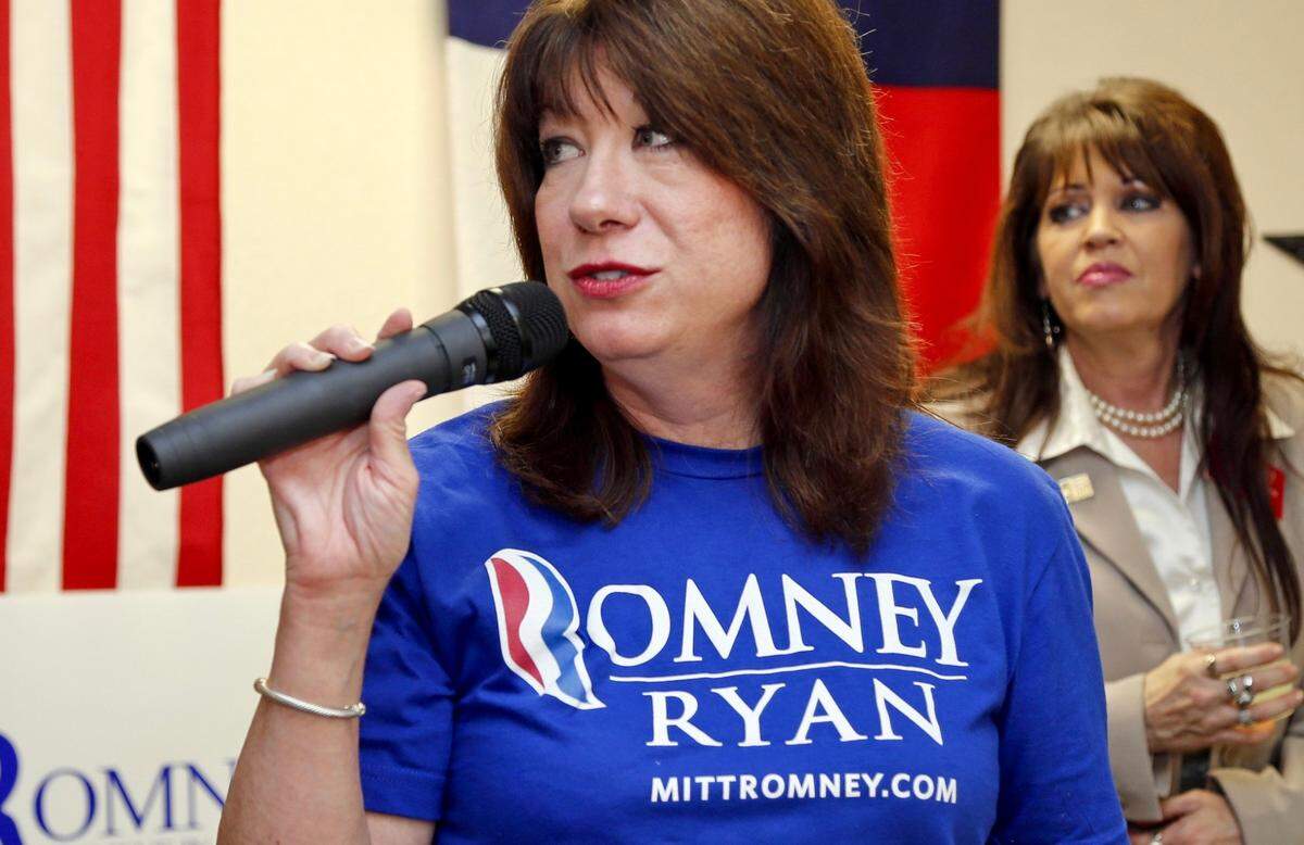Leslie Recine speaking to a gathering as Burleson Republican Shanda Perkins listens during the North Texas Victory Center Republican office opening in Arlington, Texas, on September 24, 2012.