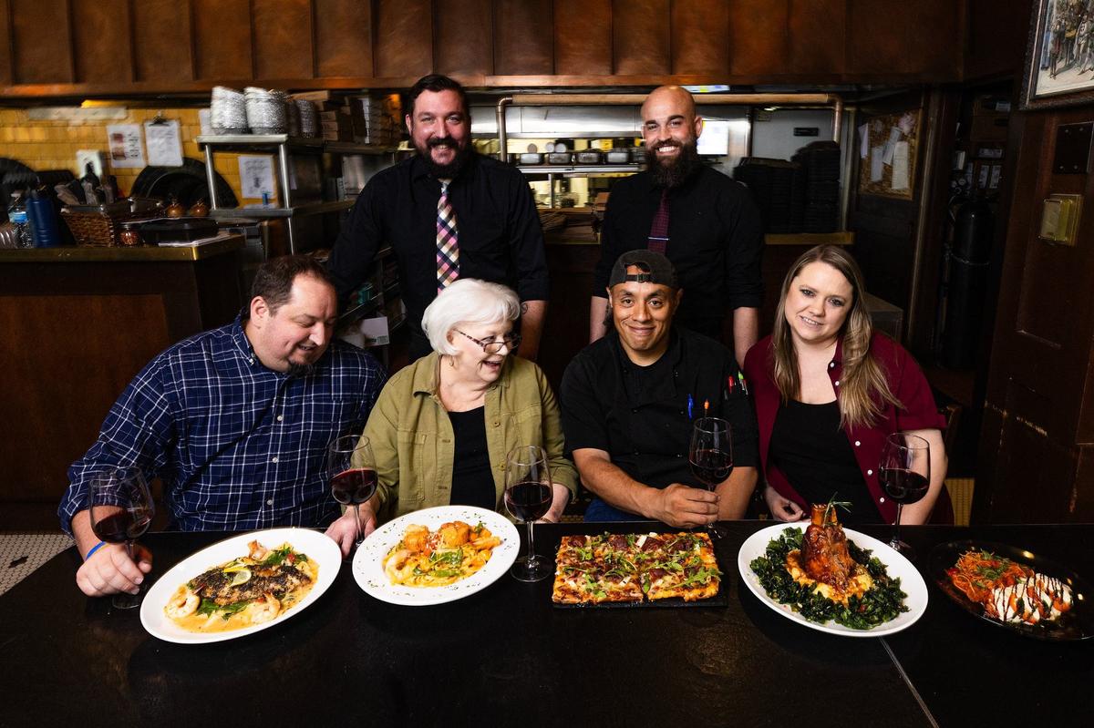 Members of the leadership including General Manager Brin Burke (bottom left), Restaurant owner Joyce Russell (bottom second from left), Head Chef Louis Castro (bottom second from right), and Assistant General Manager Shannon McPeters (bottom right) are photographed in the dinig room of Italianni’s Pasta, Pizza and Vino in Hurst on Tuesday, July 9, 2024.