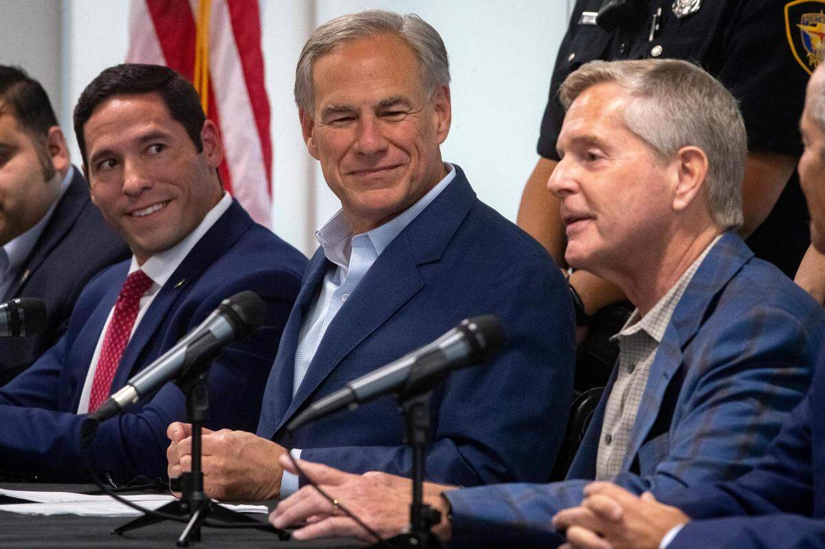 Texas governor Greg Abbott listens to Rep. Phil King, a former Fort Worth police officer, speak during a press conference at the Fort Worth Police Officers Association on Wednesday, Sept. 14, 2022.
