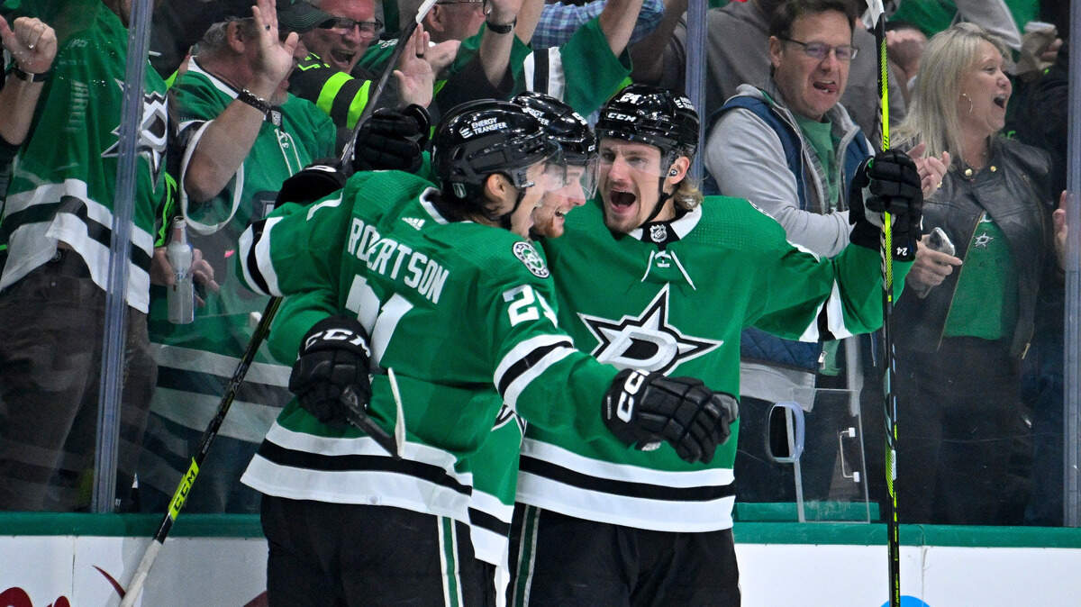 Dallas Stars left wing Jason Robertson (21) and defenseman Thomas Harley (55) and center Roope Hintz (24) celebrates a goal scored by Hintz against the Seattle Kraken during the first period in game five of the second round of the 2023 Stanley Cup Playoffs at American Airlines Center.