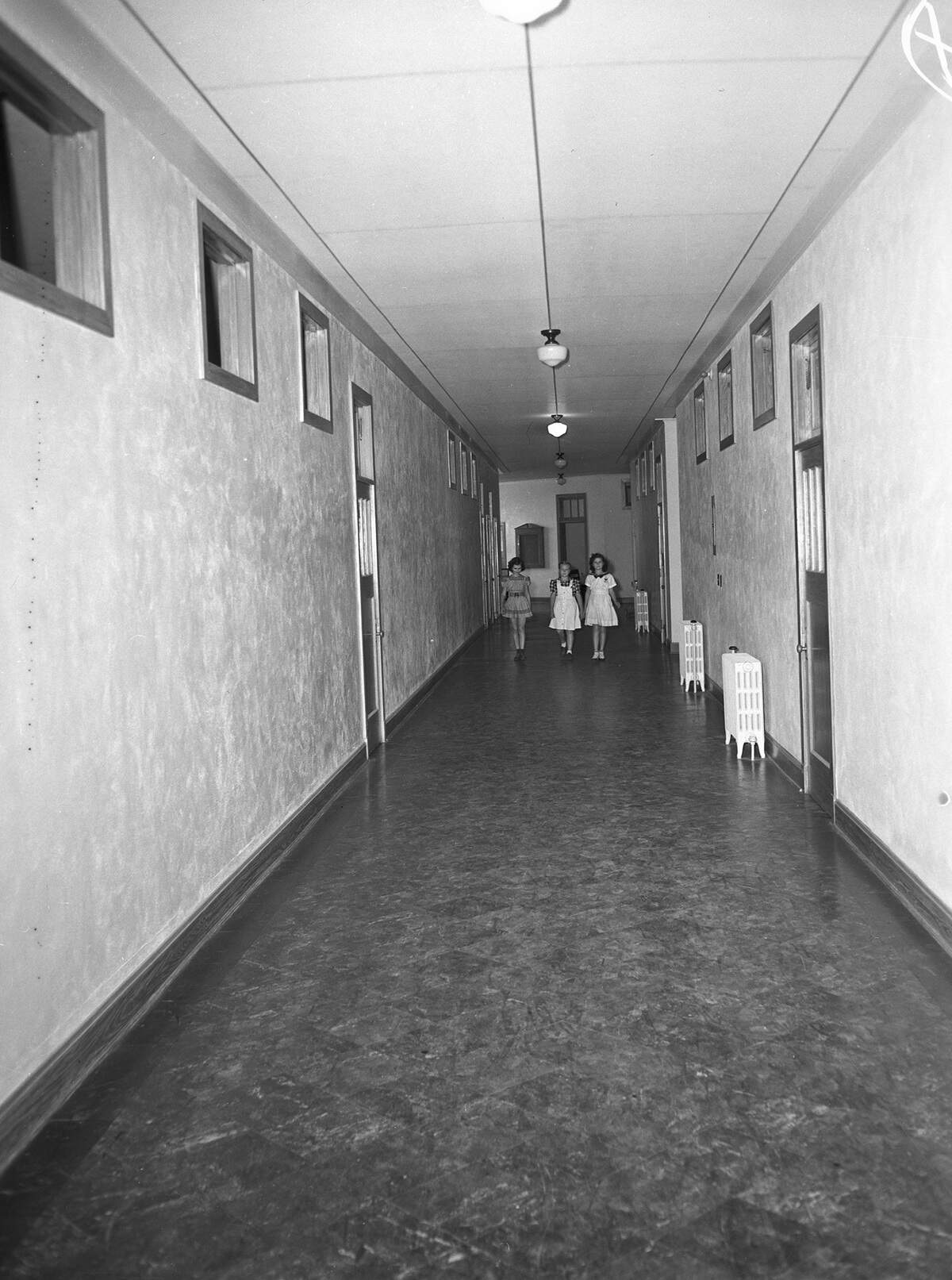 Sept. 11, 1941: The new Sagamore Hill Elementary School is opening to begin the fall term. The old building was condemned after a fire and the new red brick school house took two years to complete. In the meantime, students attended school in the adjoining district. Strolling down a corridor on the first day are fourth-grade pupils, Norma Jean Havenhill (left), Betty Ruth Tomkins and Laura Ann Vickers.