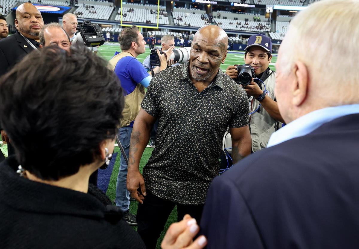 Mike Tyson, center, talks to New Orleans Saints owner Gayle Benson and Jerry Jones before the start of the Dallas Cowboys and New Orleans Saints matchup on Sunday, Sept. 15, 2024, at AT&T Stadium in Arlington.
