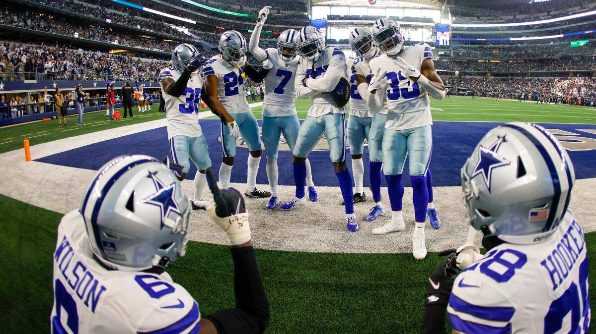 The Dallas Cowboys defense celebrates after an interception during the first half of an NFL football game against the Philadelphia Eagles Saturday, Dec. 24, 2022, in Arlington, Texas. (AP Photo/Ron Jenkins)