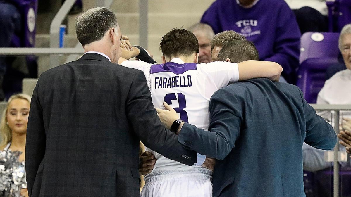 TCU head coach Jamie Dixon and TCU staff help guard Francisco Farabello (3) off the court in the first half of a NCAA basketball game at Schollmaier Arena in Fort Worth, Texas, Saturday, Feb. 22, 2020. Farabello sustained a concussion and was down for several minutes. TCU trailed by two at the halfway point. (Special to the Star-Telegram Bob Booth)
