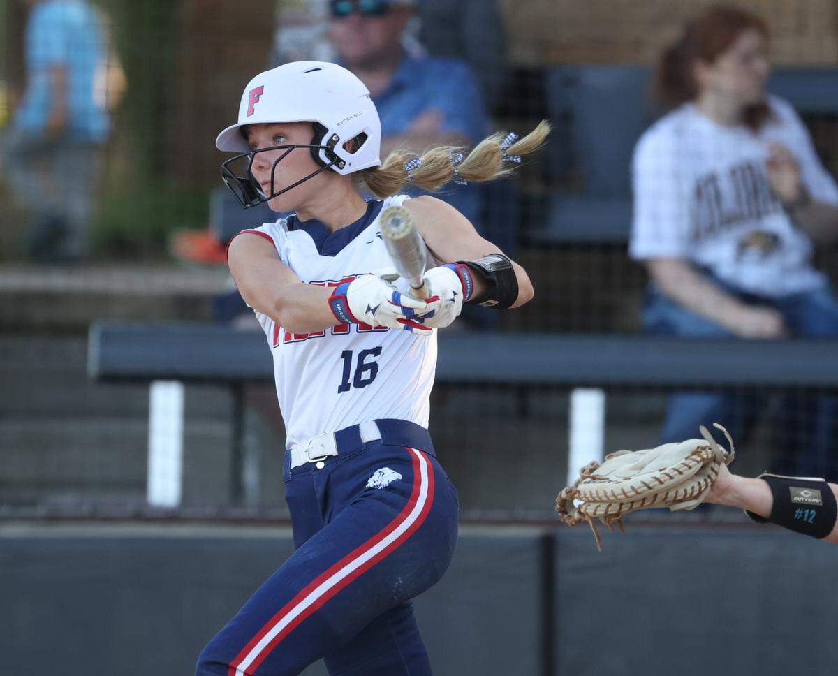 Grapevine Faith center fielder Michaela Hamilton watches her fly ball travel to the outfield during a softball game at Oak Grove Park in Grapevine, Tx. Tuesday, March 31, 2026