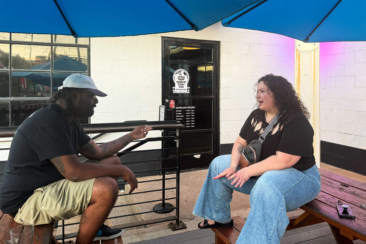 Sid Telidevara, left, and Nicole Surrey talk about their experiences following a fire at The Cooper in Fort Worth during a gathering for tenants at HopFusion Ale Works on July 10. Telidevara and Surrey were neighbors when they lived at The Cooper. Both have signed on to a new lawsuit related to the fire.