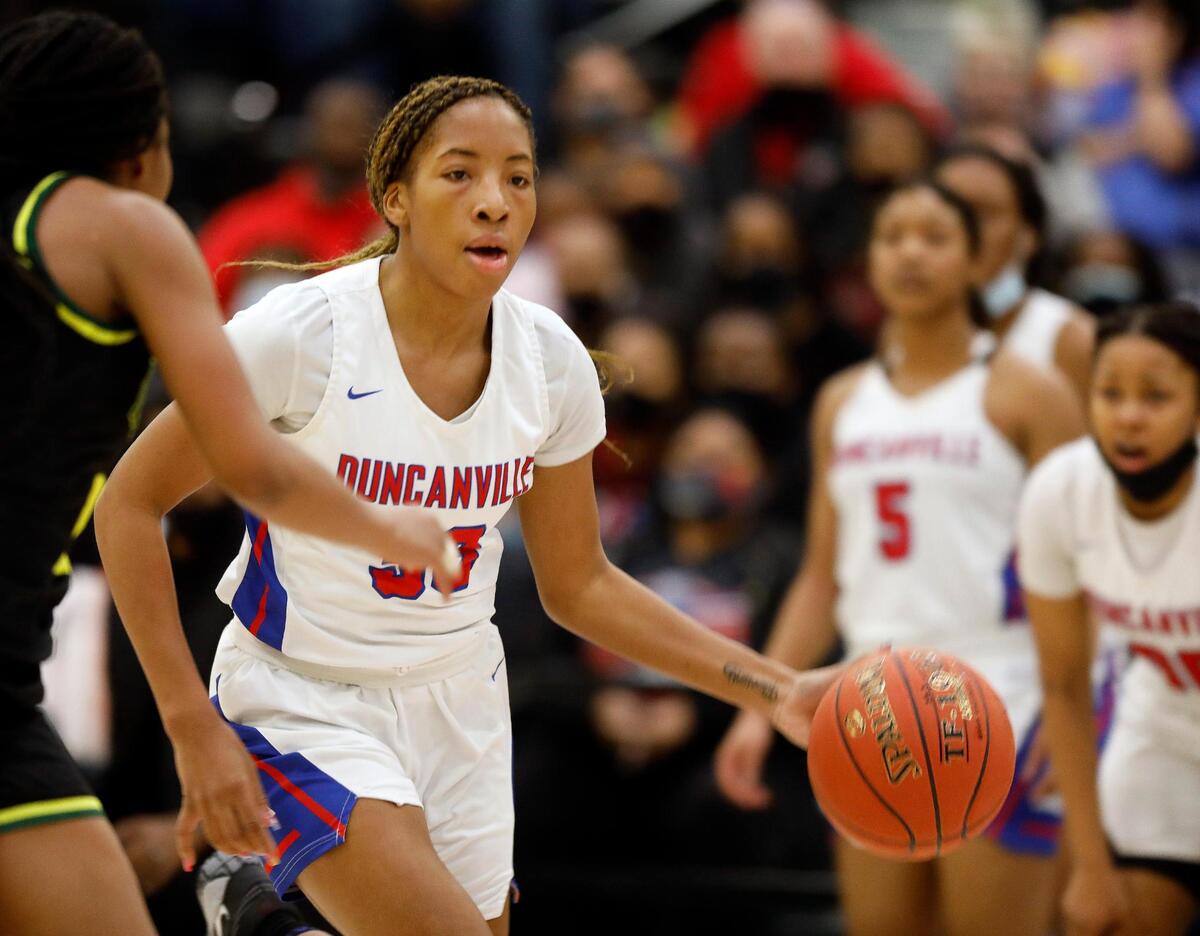 Duncanville guard Nyah Wilson (33) brings the ball down court during the second half of the 6A Region II Regional Final basketball game at Waxahachie High School in Waxahachie, Texas, Tuesday, March 02, 2021. DeSoto defeated Duncanville . 52-39. (Special to the Star-Telegram Bob Booth)
