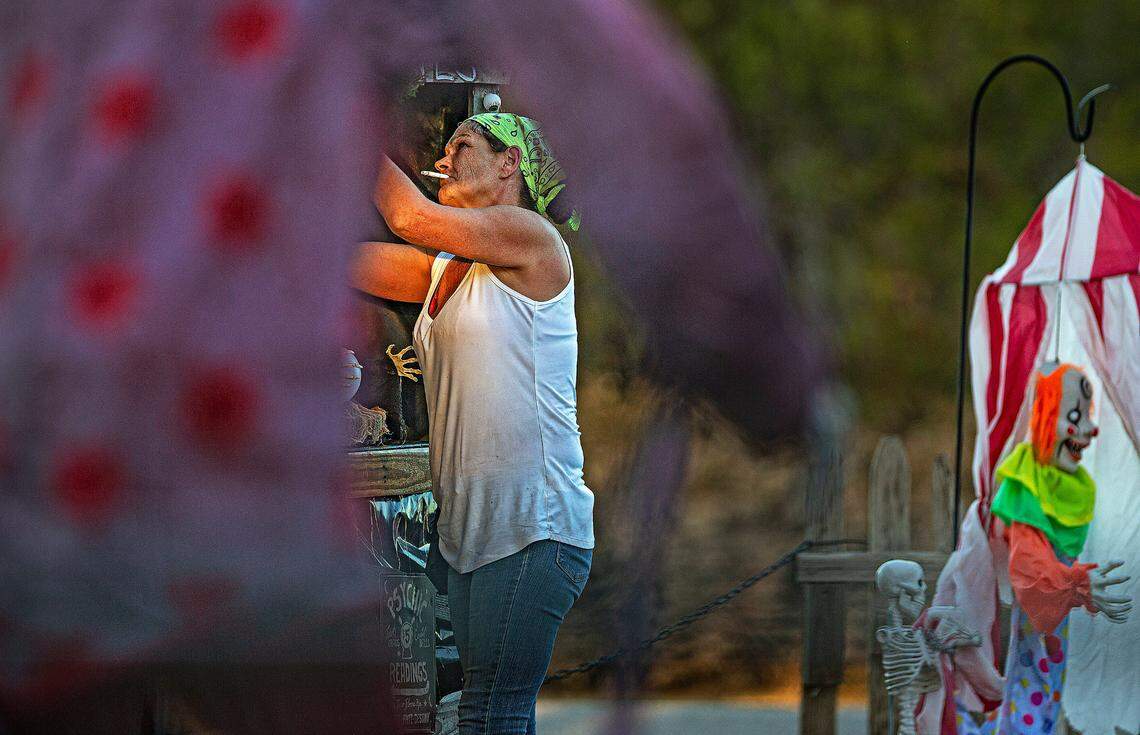 With a Pall Mall cigarette dangling precariously on thin lips, Chris Caughlan scurried about checking batteries and power cords and switching on figures before the day died and guests arrived.