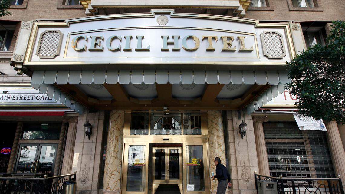 A visitor arrives at the hotel Cecil on Wednesday Feb. 20,2013 where police say the body of a woman was found wedged in one of the water tanks on the roof was that of a missing Canadian guest. Investigators used body markings to identify 21-year-old Elisa Lam, police spokeswoman Officer Diana Figueroa said late Tuesday. A maintenance worker at the Cecil Hotel found the body earlier in the day after guests complained of low water pressure. (AP Photo/Nick Ut)