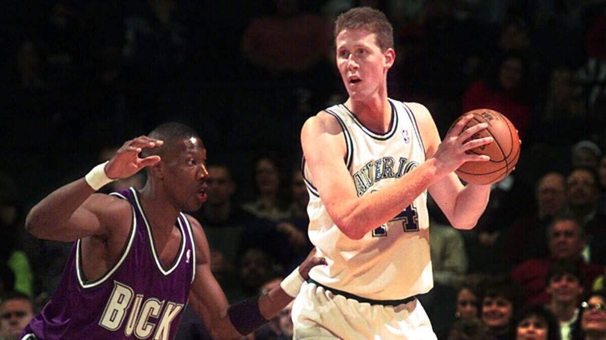 Dallas Mavericks’ Shawn Bradley (44) looks to pass against Milwaukee Bucks’ Ervin Johnson (40) during the first quarter at the Reunion Arena in Dallas, Saturday, Nov. 22, 1997. Bradley recorded his 1,000th career block during the game. (AP Photo/LM Otero)